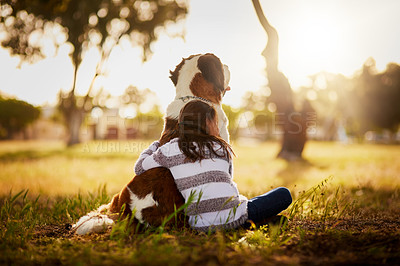 Buy stock photo Rearview shot of a cute little boy hugging her dog while they sit outside
