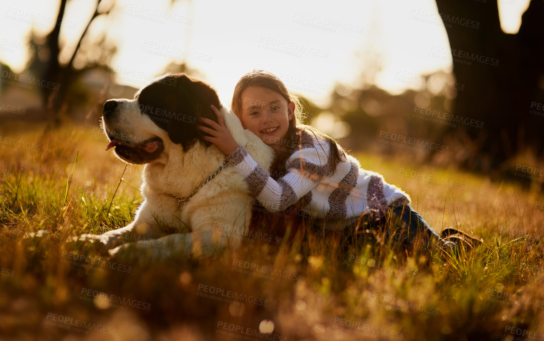 Buy stock photo Portrait of a cute little girl cuddling with her dog while they play outside