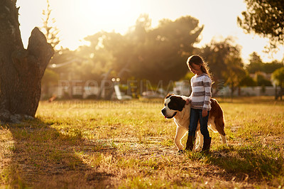 Buy stock photo Shot of a cute little girl walking through a park with her dog
