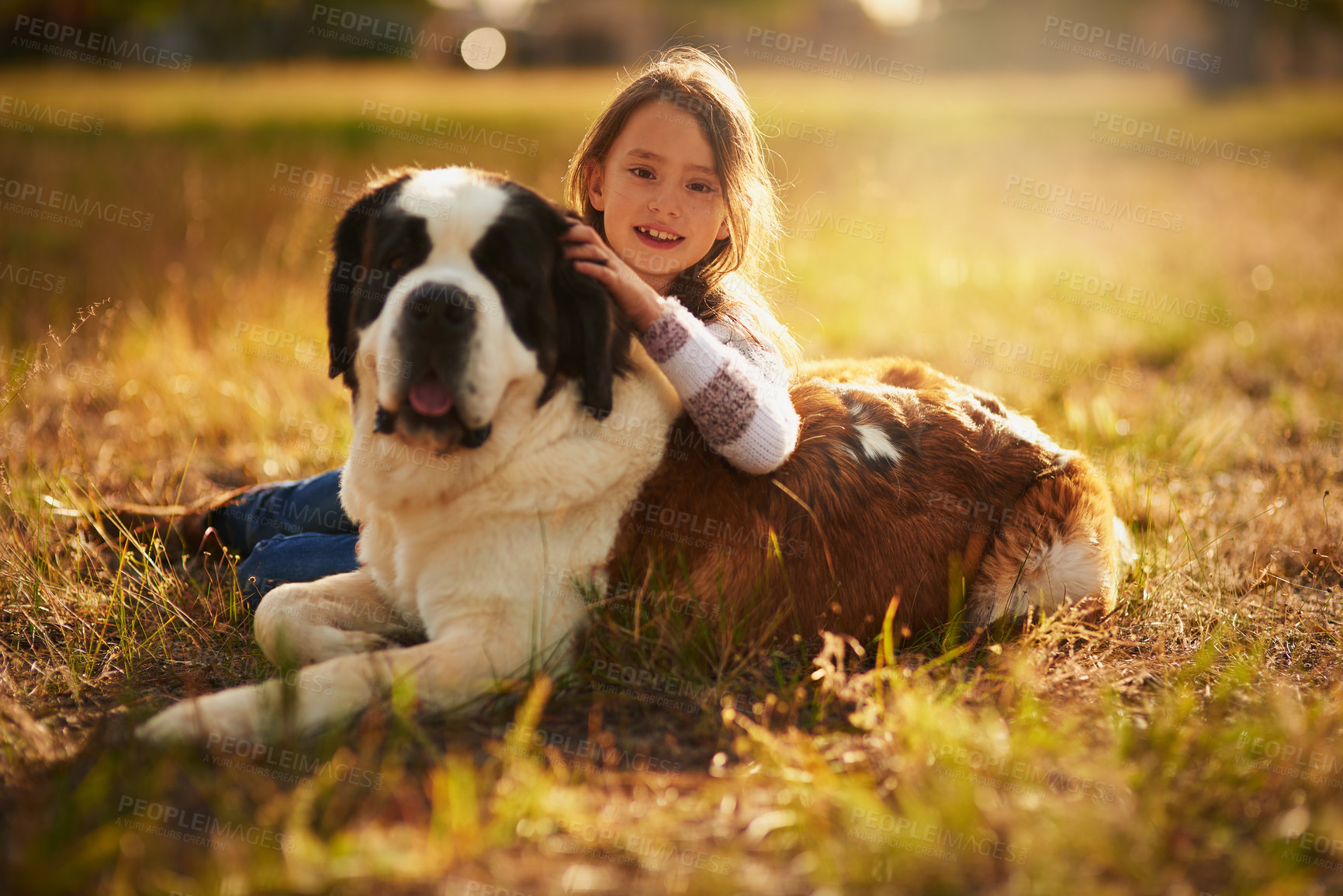 Buy stock photo Portrait of a cute little girl hugging her dog while they play outside
