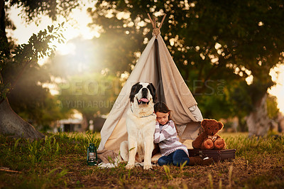 Buy stock photo Shot of a cute little girl playing outside a teepee with her dog