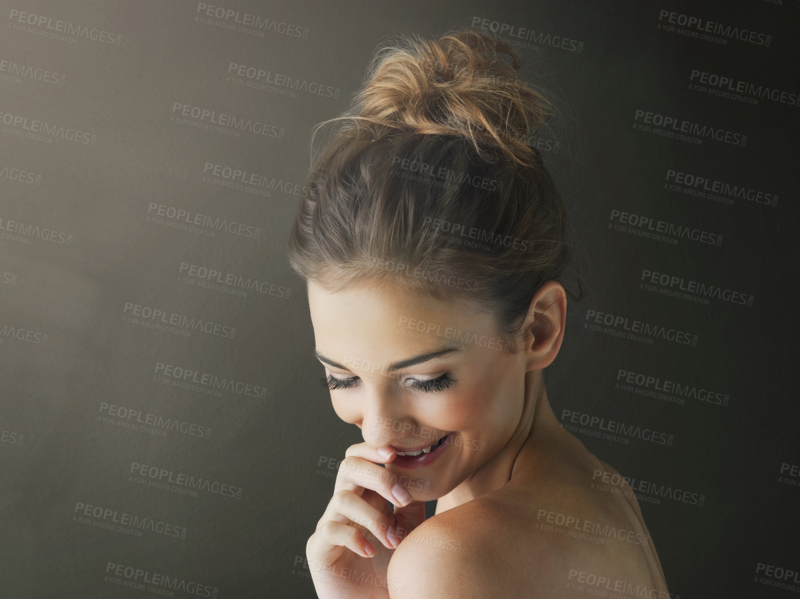 Buy stock photo Studio shot of a beautiful young woman posing against a brown background