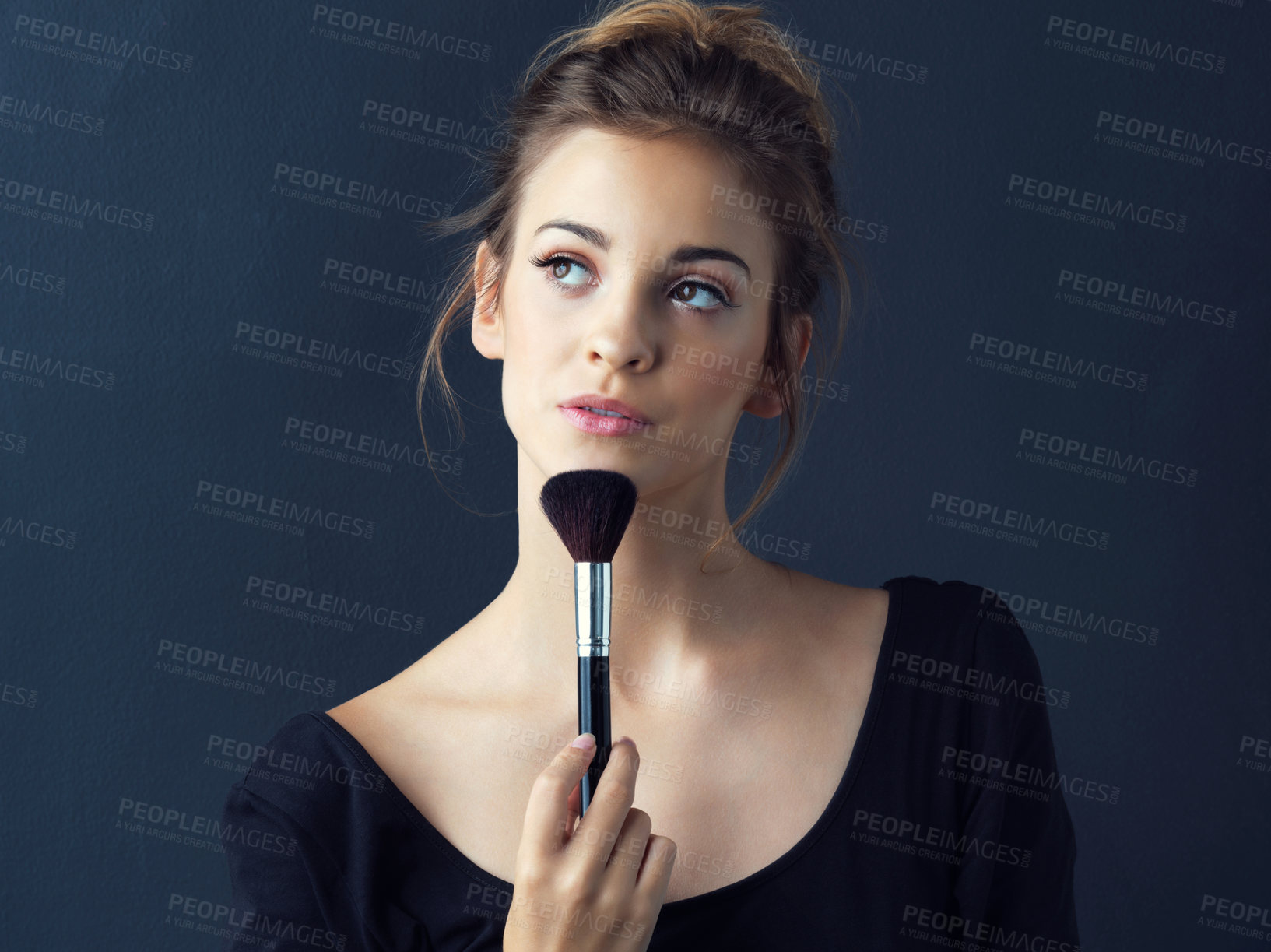 Buy stock photo Cropped shot of a beautiful young woman posing with her makeup brush