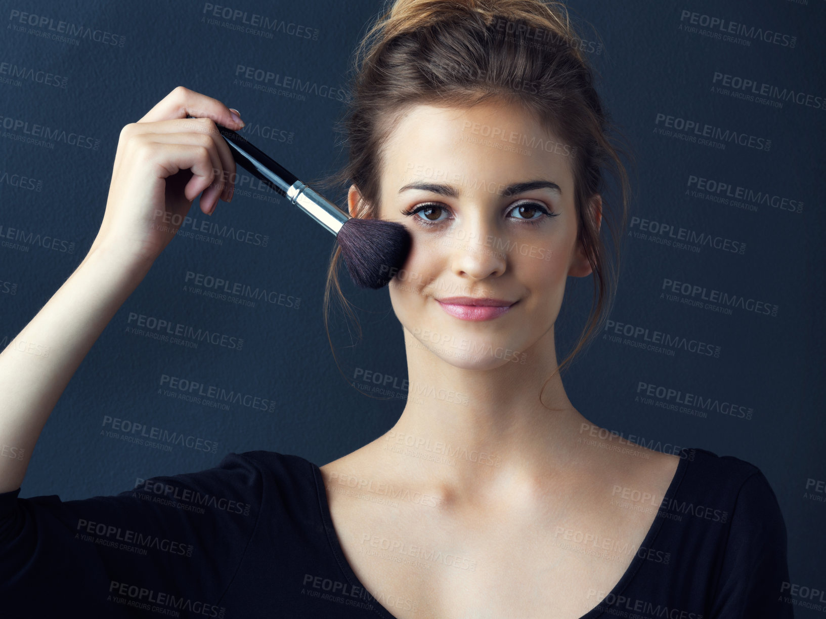 Buy stock photo Happy woman, portrait and beauty with makeup brush for foundation or blush on a blue studio background. Young female person or model with smile in facial treatment for cosmetics, glow up or shine