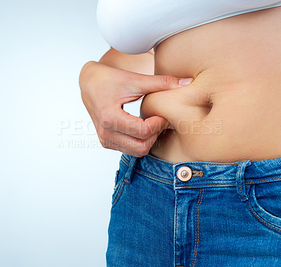 Buy stock photo Woman, hands and stomach pinch on white background for weight loss or health, body transformation or diet for wellness. Female person, studio and abdomen fat with grip for results with liposuction