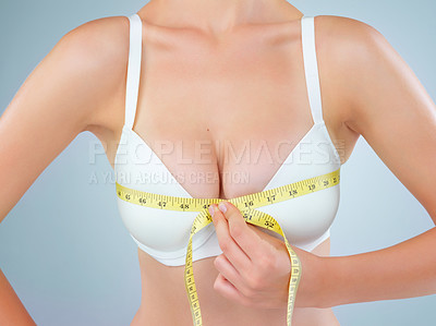 Buy stock photo Woman, lingerie and measuring tape on chest for cup size, support or breast in gray background. Female person, self esteem and wellness in bust fitting, band and check for boobs or overbust in studio