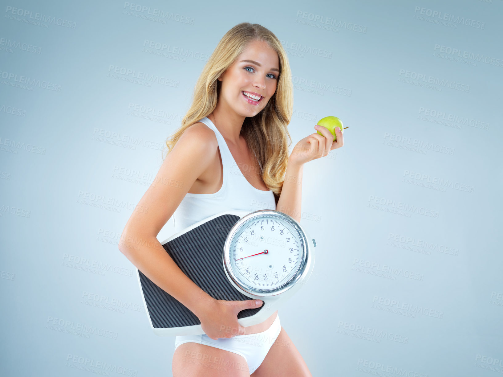 Buy stock photo Woman in portrait, smile with apple and scale, lose weight and healthy food isolated on studio background. Female model, health and diet with organic fruit, mockup space and happiness with weightloss