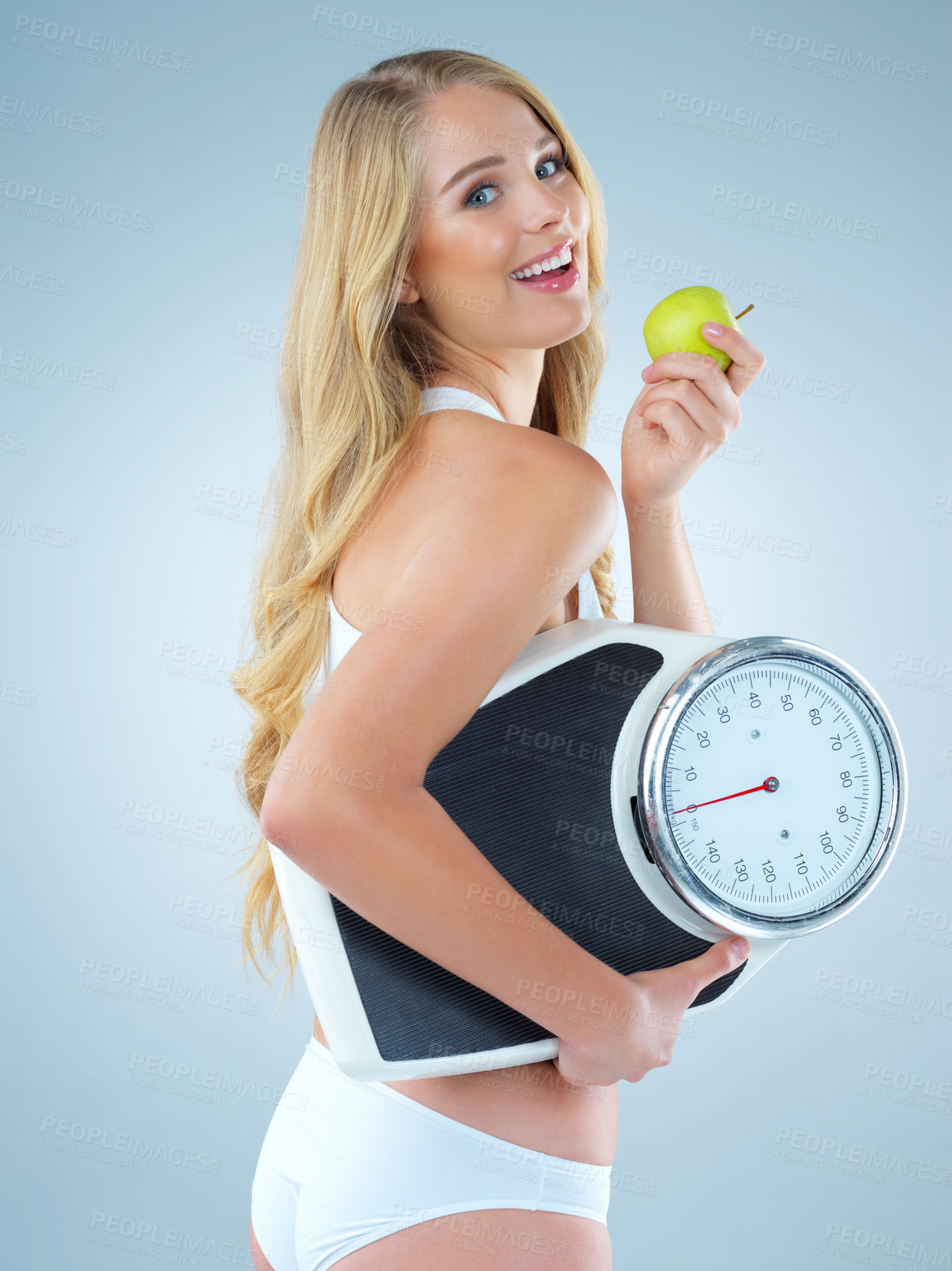 Buy stock photo Woman is eating apple, smile with scale and lose weight, portrait and healthy food isolated on studio background. Happy female model, health and diet with organic fruit with nutrition and weightloss