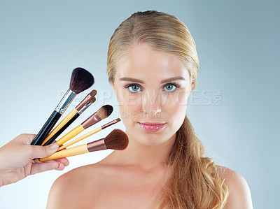 Buy stock photo Woman, studio and confident with beauty brushes for makeup salon and cosmetics in gray background. Female person, aesthetics and portrait with tools or kit for grooming, foundation and glow skin