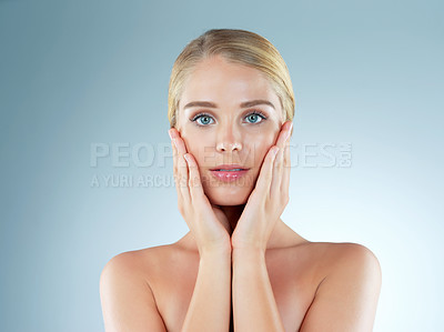 Buy stock photo Woman, portrait and skincare feeling in studio, transformation and beauty on blue background. Female person, cosmetics and foundation for smooth skin, facial treatment and hands for dermatology pride