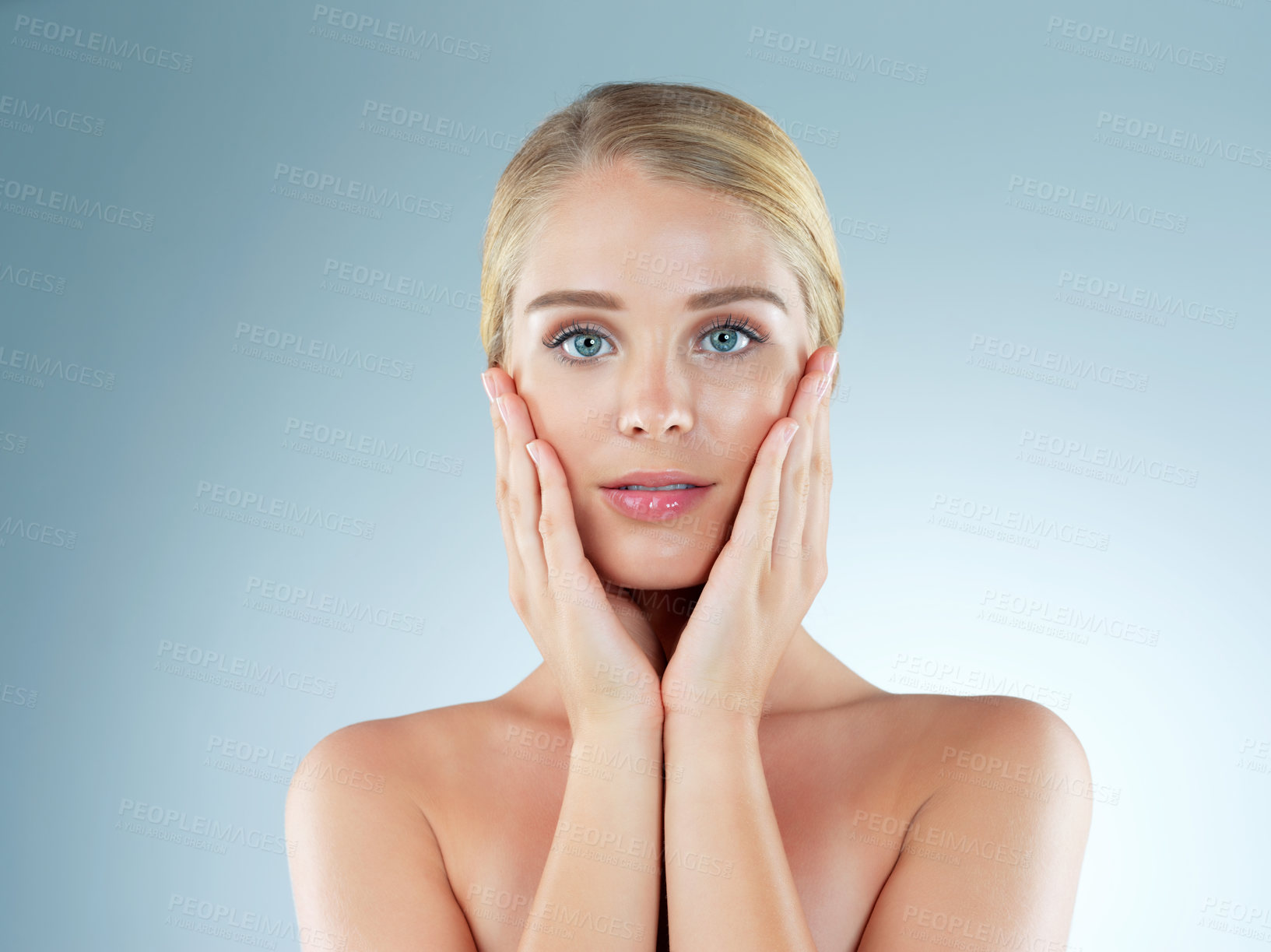 Buy stock photo Woman, portrait and skincare feeling in studio, transformation and beauty on blue background. Female person, cosmetics and foundation for smooth skin, facial treatment and hands for dermatology pride