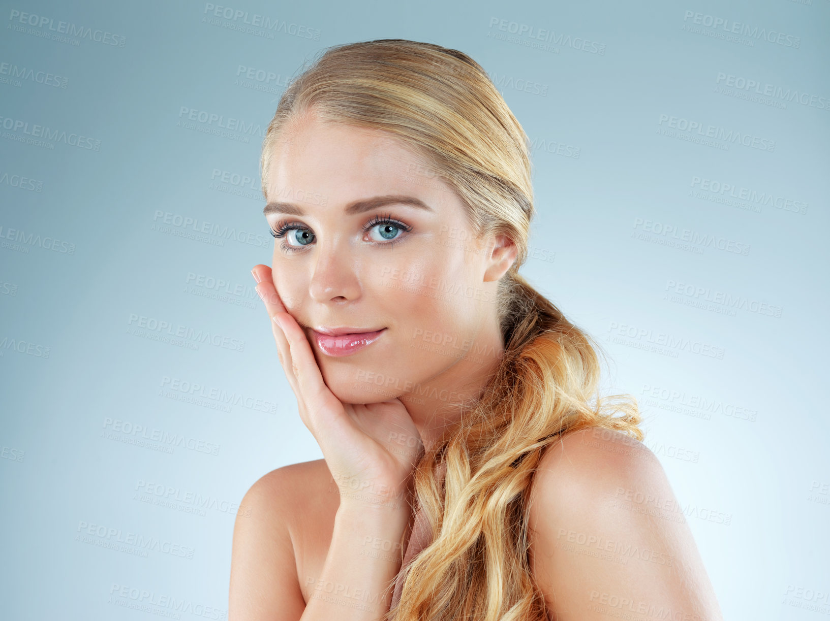 Buy stock photo Woman, portrait and cosmetics feeling in studio, transformation and beauty on blue background. Female person, skincare and foundation for smooth skin, facial treatment and dermatology pride for glow