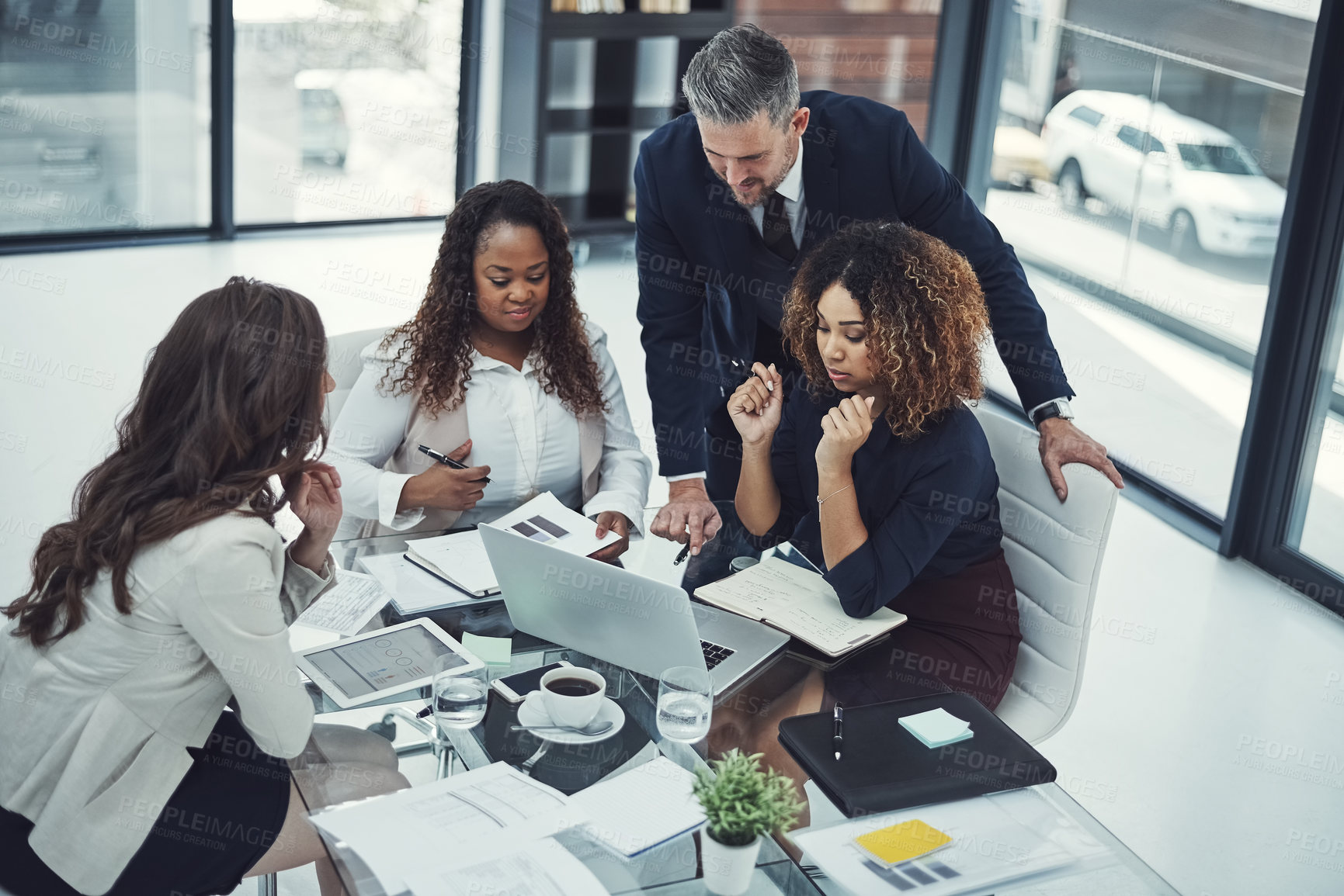 Buy stock photo Shot of a group of colleagues having a meeting in a modern office