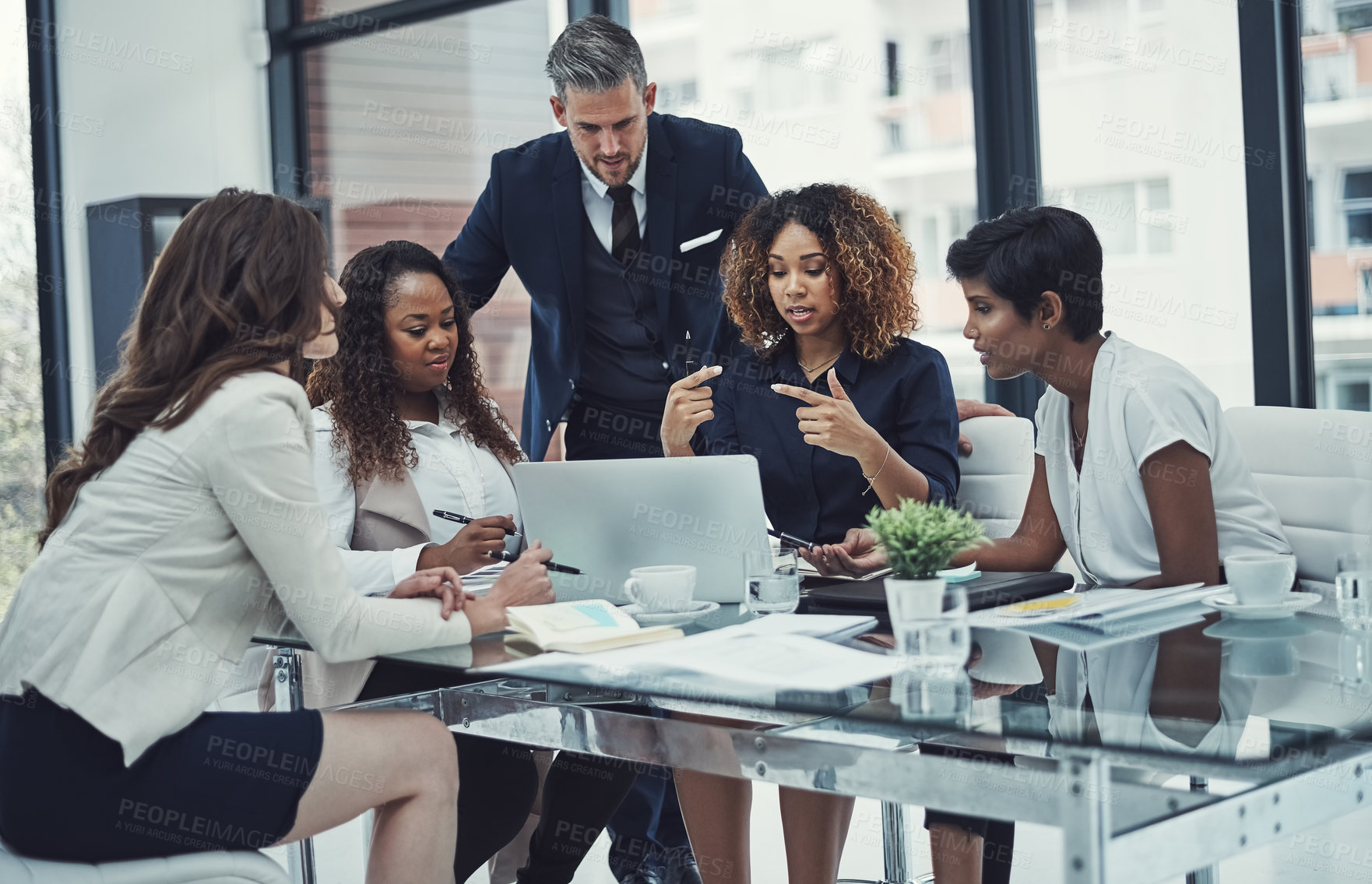 Buy stock photo Shot of a group of colleagues having a meeting in a modern office