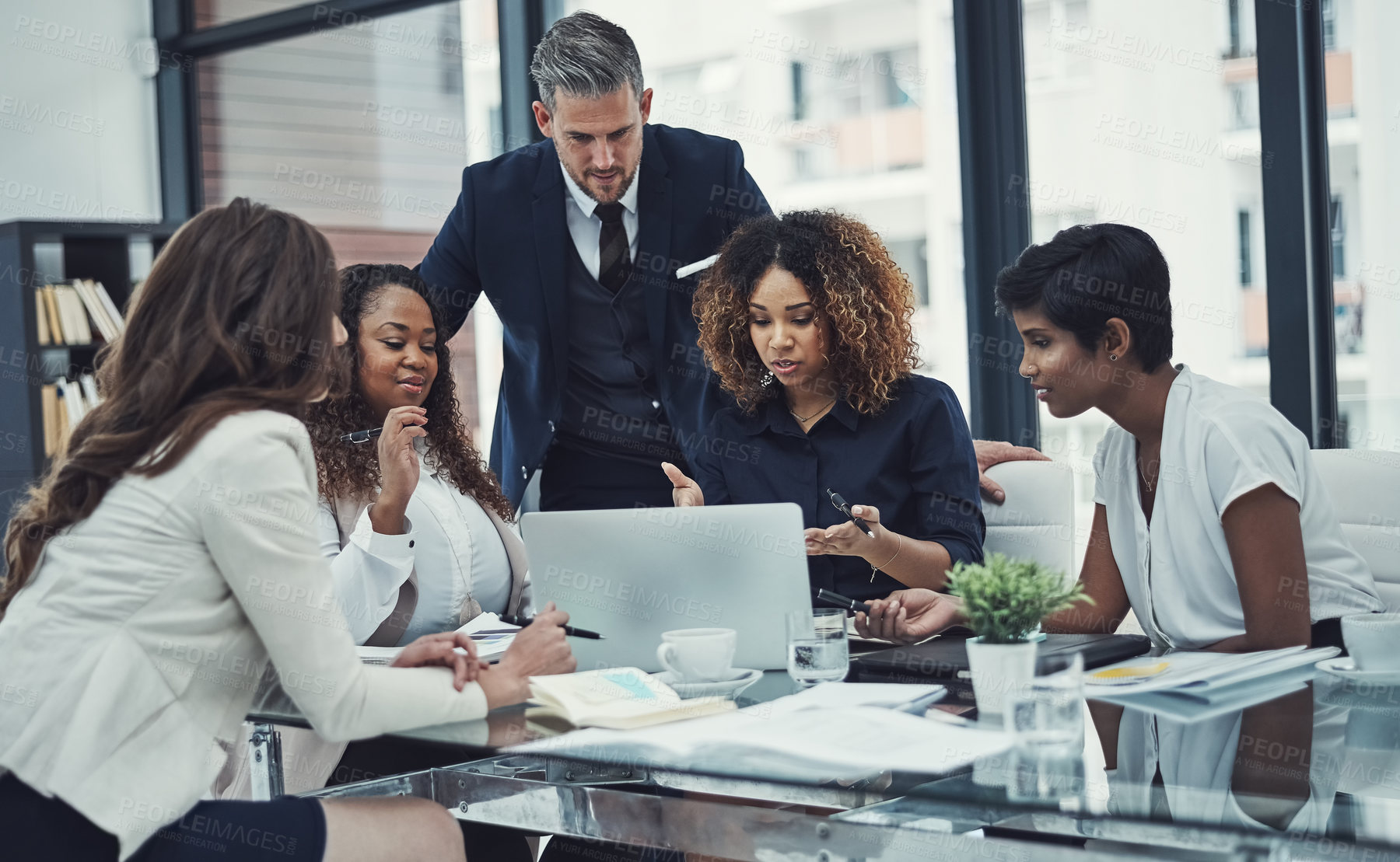 Buy stock photo Shot of a group of colleagues having a meeting in a modern office