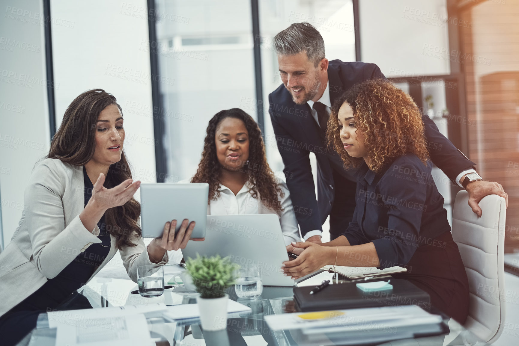 Buy stock photo Shot of a group of corporate businesspeople meeting in the boardroom