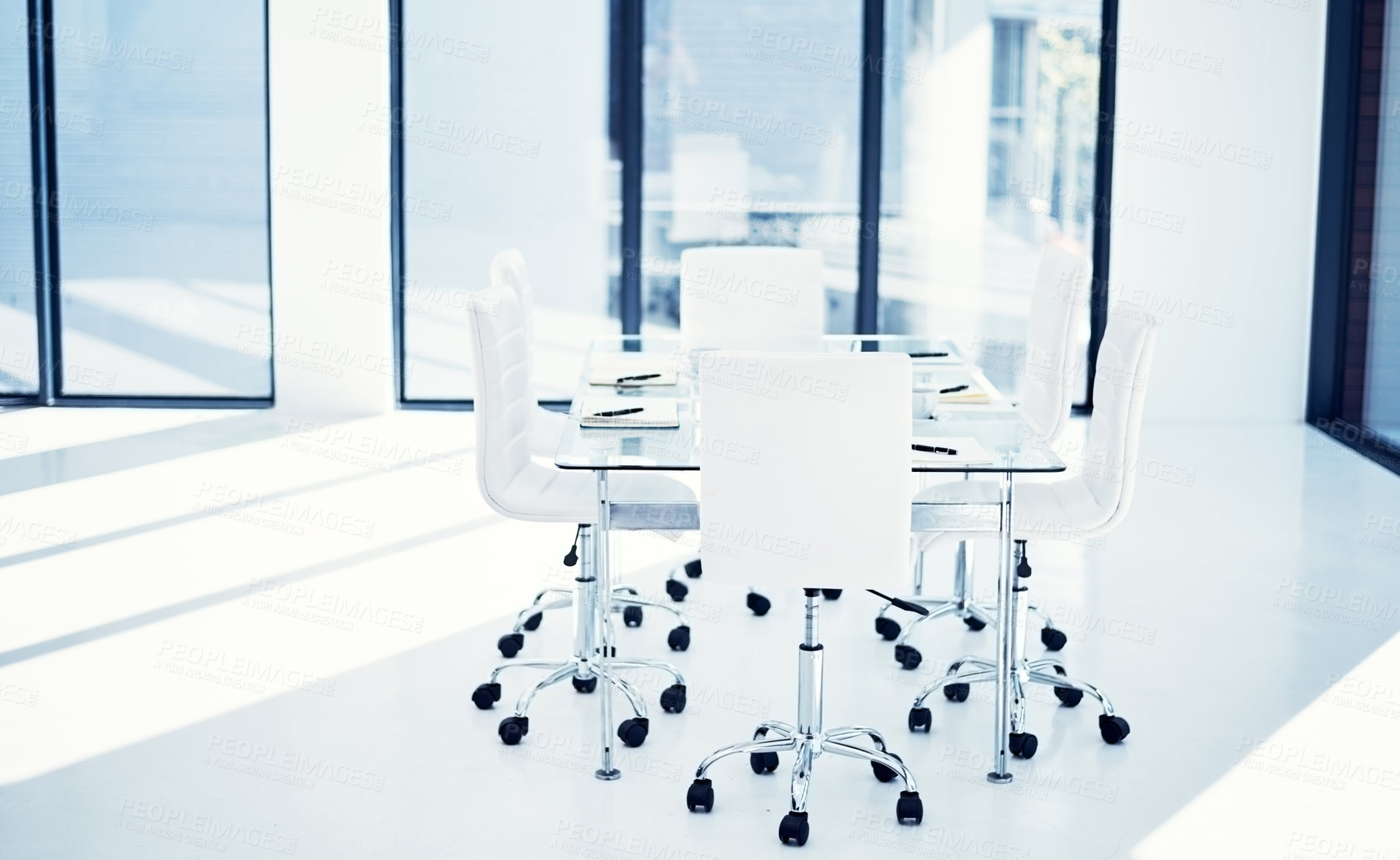 Buy stock photo Shot of an empty boardroom furnished with a table and chairs