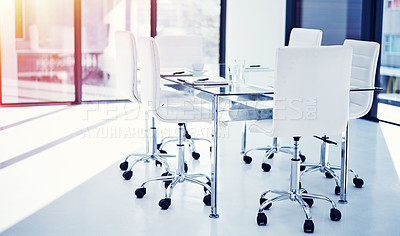 Buy stock photo Shot of an empty boardroom furnished with a table and chairs