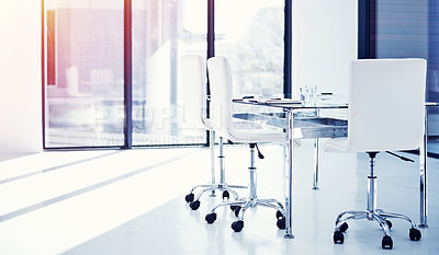 Buy stock photo Shot of an empty boardroom furnished with a table and chairs