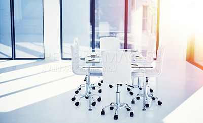 Buy stock photo Shot of an empty boardroom furnished with a table and chairs