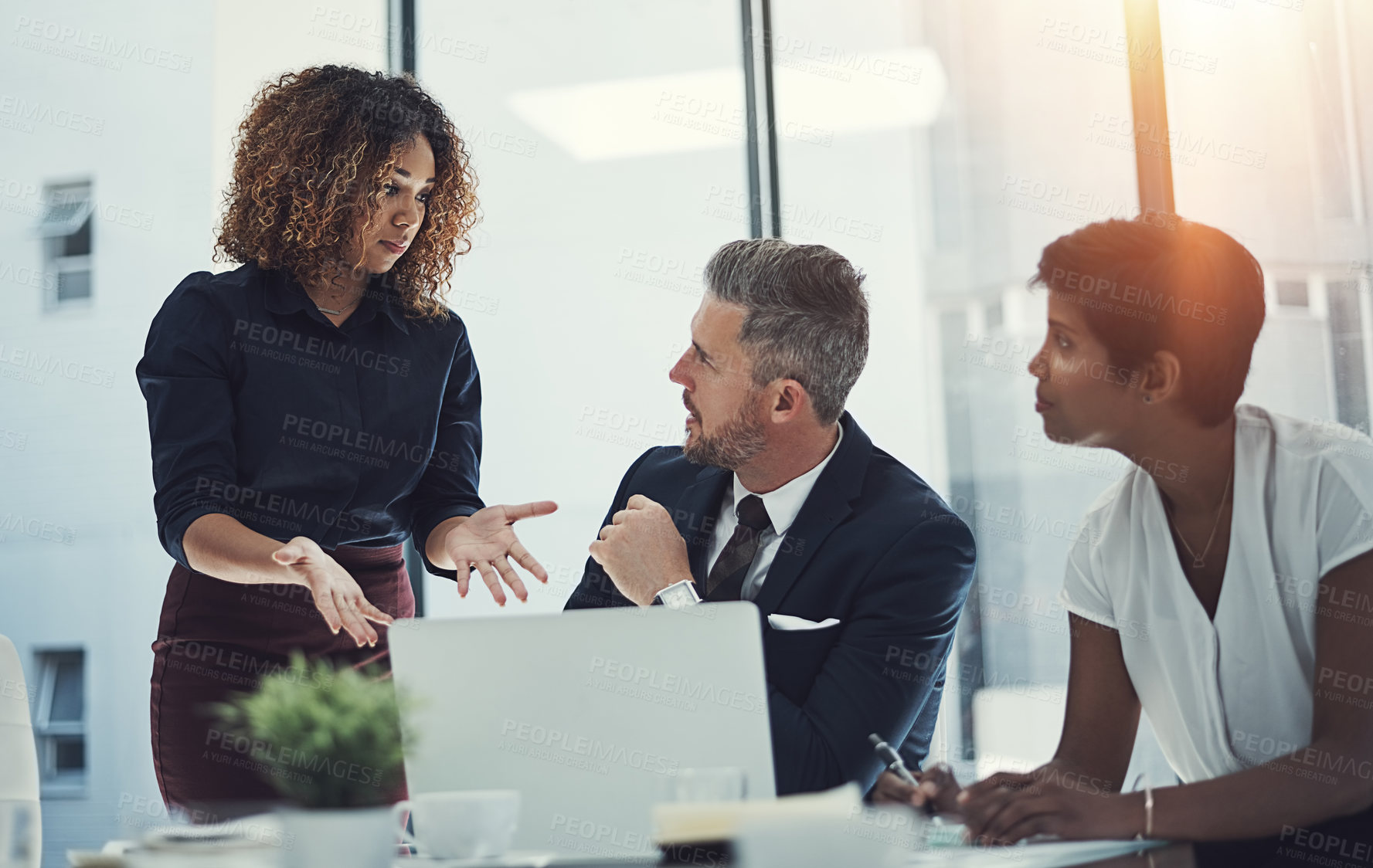 Buy stock photo Shot of a group of businesspeople having a meeting in the boardroom