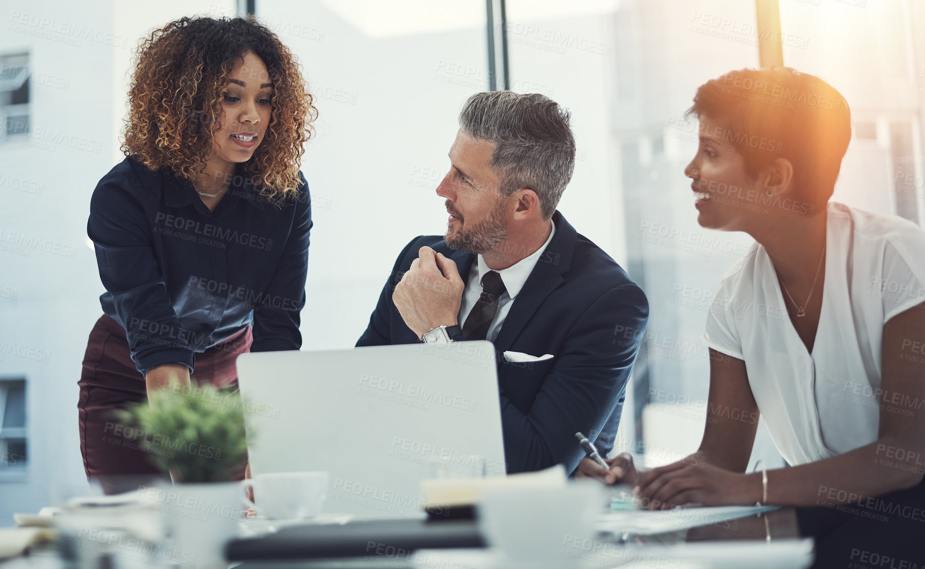 Buy stock photo Shot of a group of businesspeople having a meeting in the boardroom