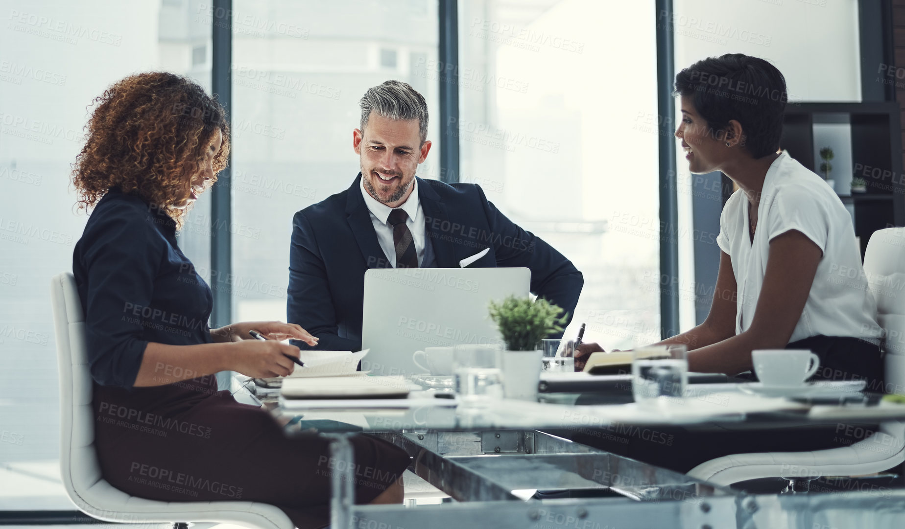 Buy stock photo Shot of a group of businesspeople having a meeting in the boardroom