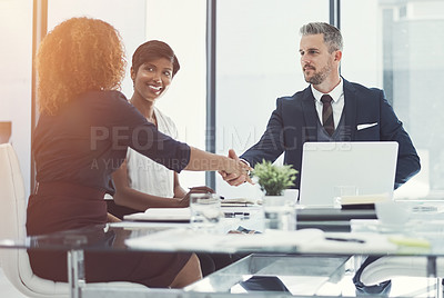 Buy stock photo Shot of a group of businesspeople having a meeting in the boardroom