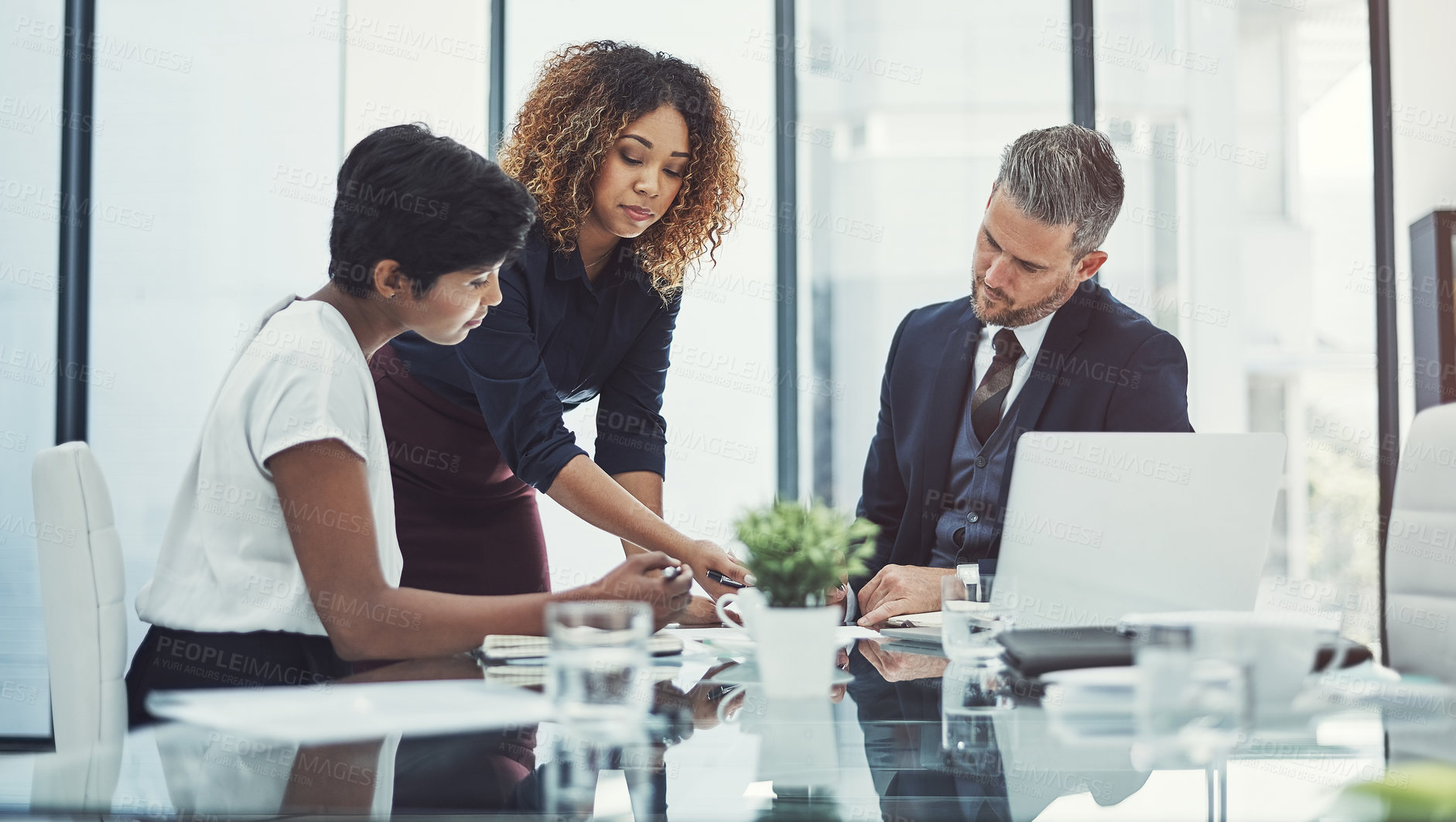 Buy stock photo Shot of a group of businesspeople having a meeting in the boardroom