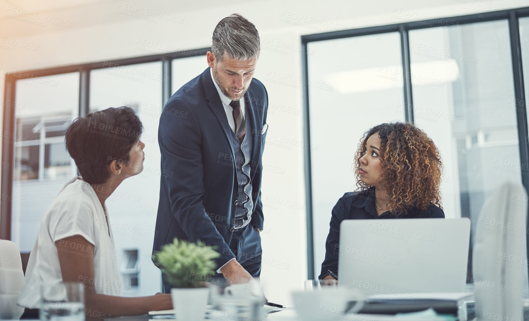 Buy stock photo Shot of a group of businesspeople having a meeting in the boardroom