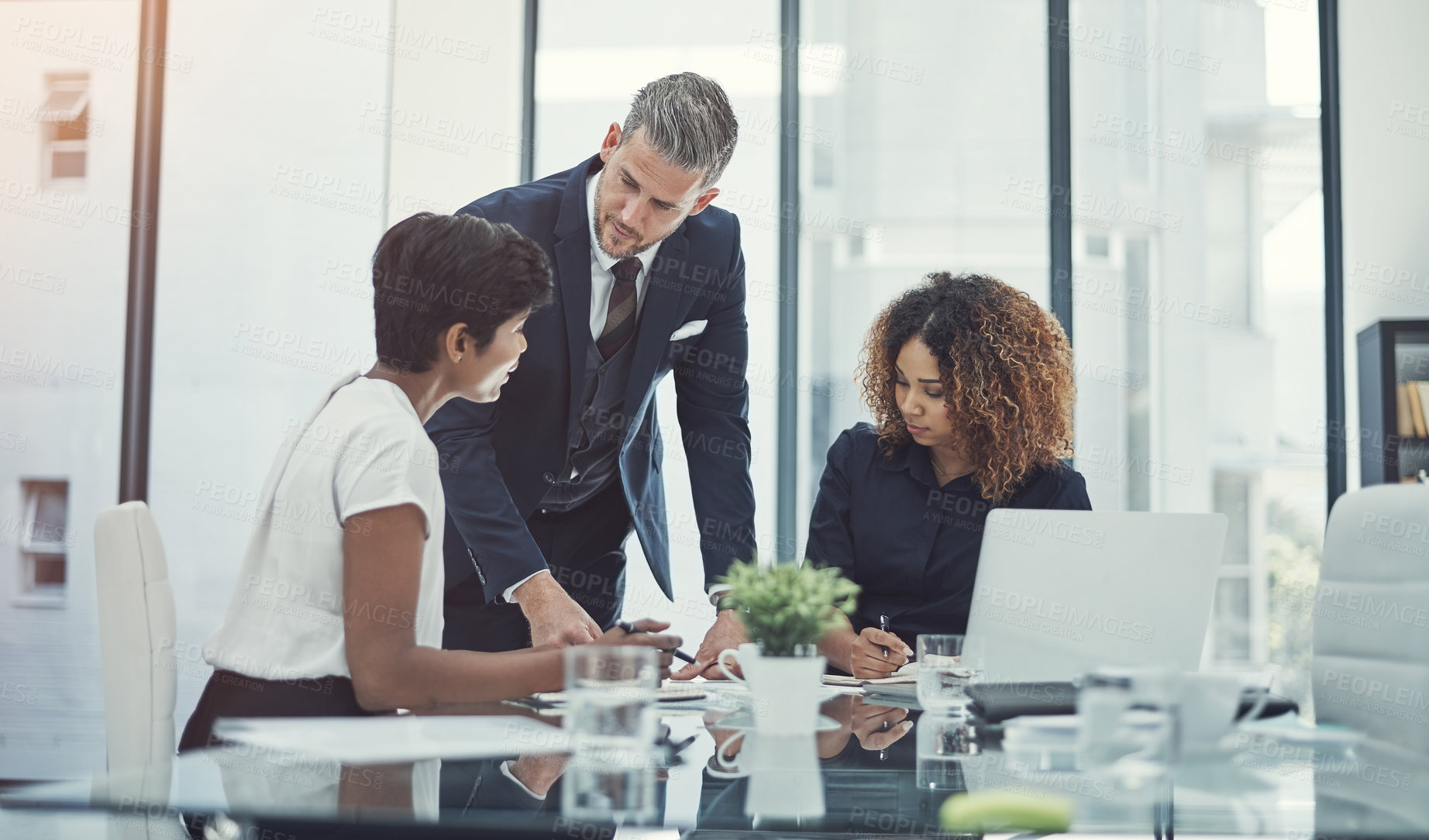 Buy stock photo Shot of a group of businesspeople having a meeting in the boardroom