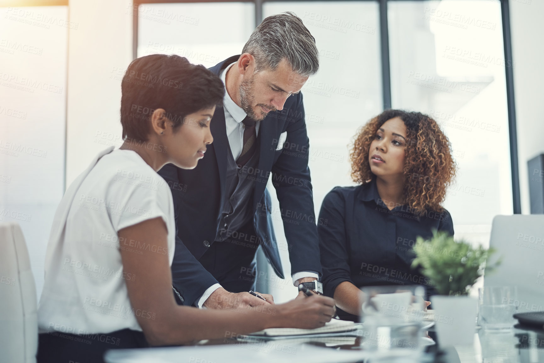 Buy stock photo Shot of a group of businesspeople having a meeting in the boardroom