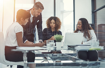 Buy stock photo Shot of a group of colleagues having a meeting in a modern office