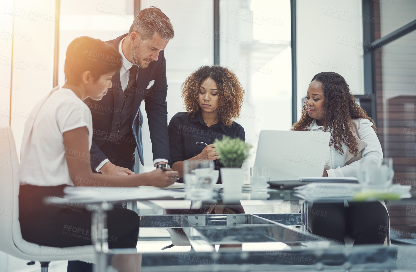 Buy stock photo Shot of a group of colleagues having a meeting in a modern office