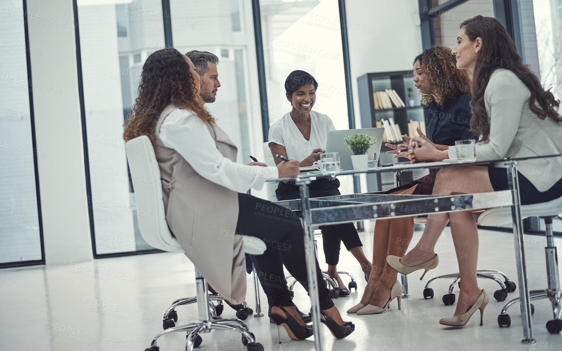 Buy stock photo Shot of a group of colleagues having a meeting in a modern office