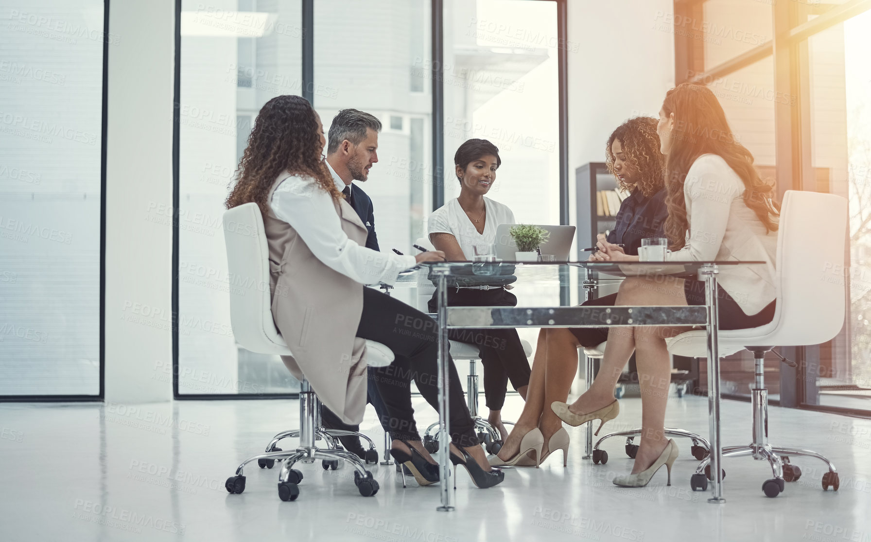 Buy stock photo Shot of a group of colleagues having a meeting in a modern office