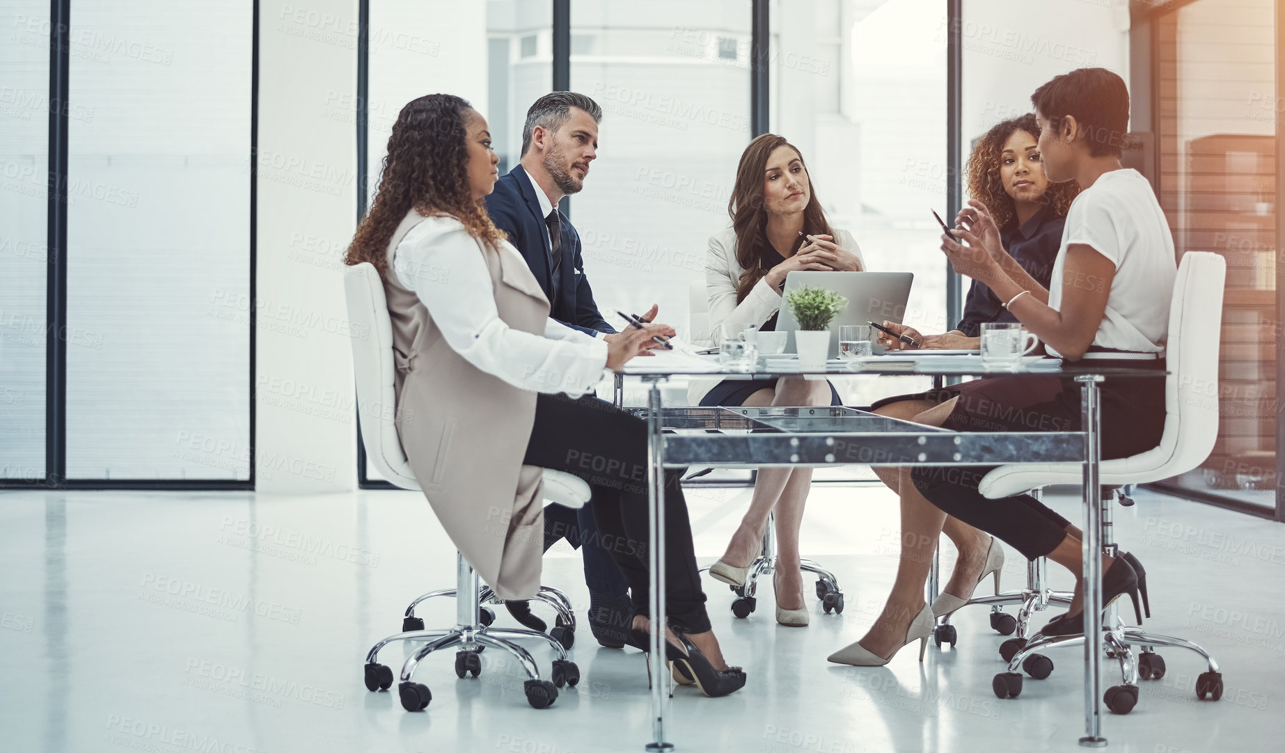 Buy stock photo Shot of a group of colleagues having a meeting in a modern office