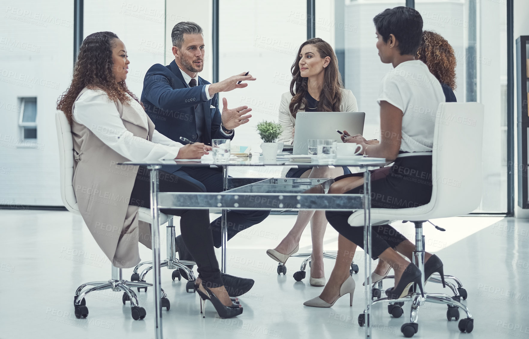 Buy stock photo Shot of a group of colleagues having a meeting in a modern office