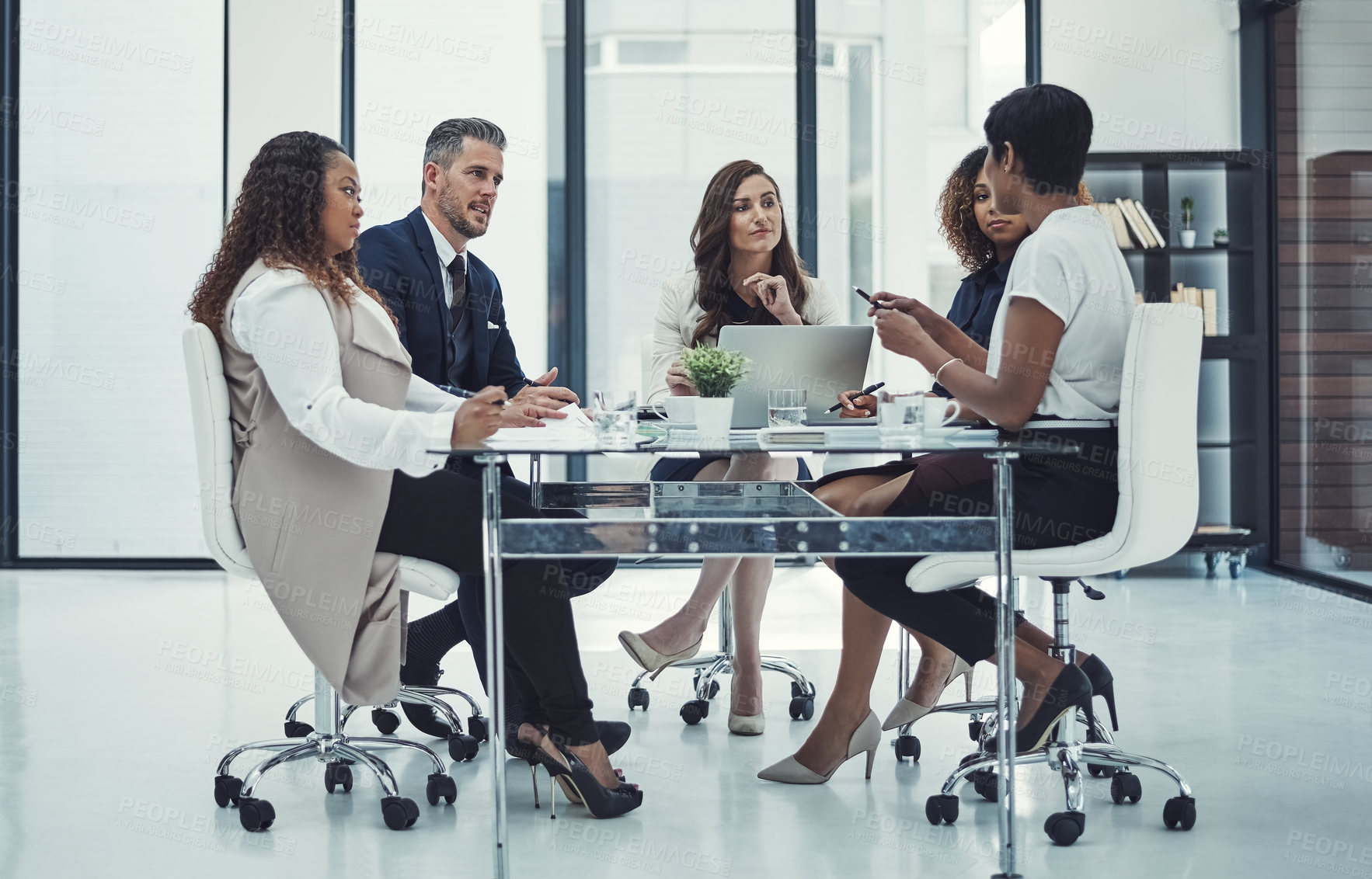 Buy stock photo Shot of a group of colleagues having a meeting in a modern office