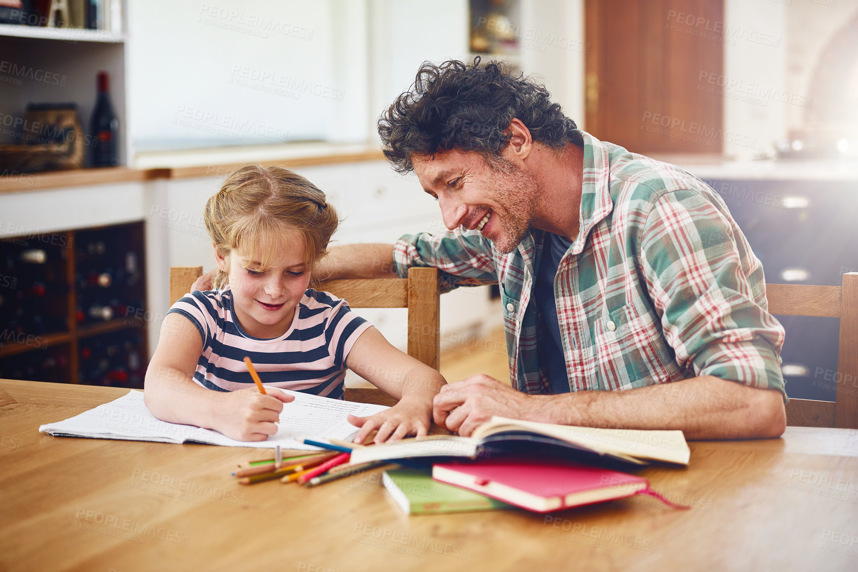 Buy stock photo Girl, father and helping with homework in home for education, learning development and support with smile. Daughter, dad and monitor school lesson, homeschooling and language activity in dining room