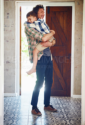 Buy stock photo Shot of a father hugging his little son as he enters the house