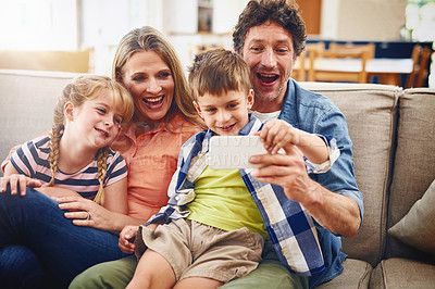 Buy stock photo Cropped shot of a family taking a selfie together at home