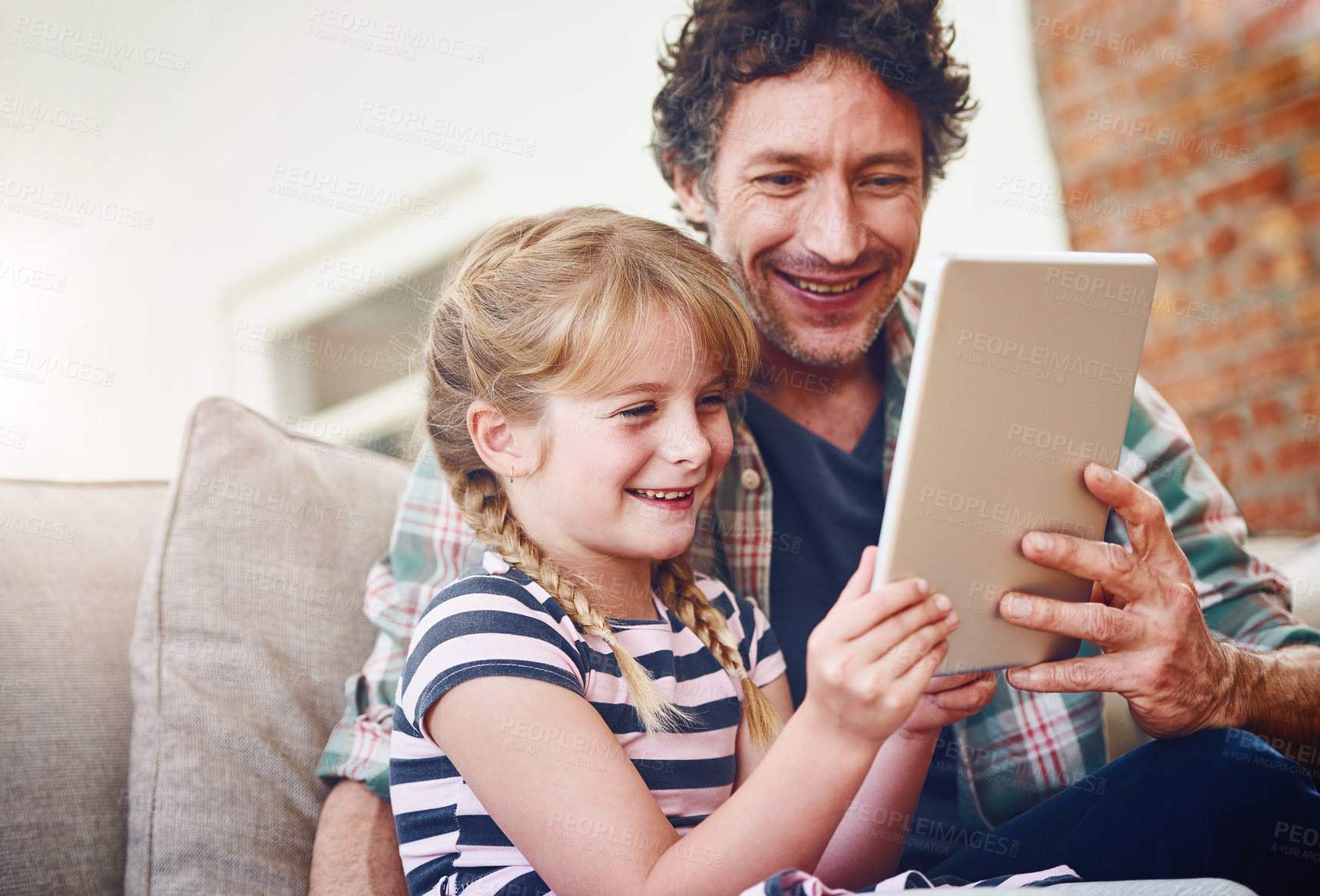 Buy stock photo Smile, dad and girl with tablet in sofa at home for elearning, child development and knowledge with growth. Parent, kid and support with help, teaching and educational games for entertainment or fun