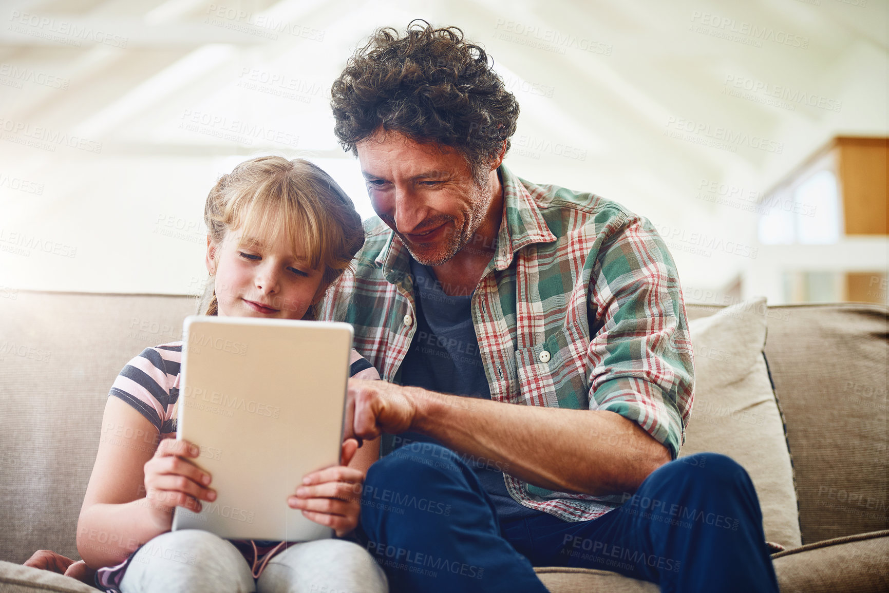 Buy stock photo Home, dad and girl with tablet on sofa with smile for  elearning, child development and knowledge with growth. Parent, kid and support with help or teaching for educational game, entertainment or fun