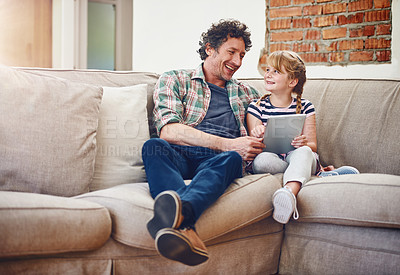 Buy stock photo Shot of a father and his little daughter using a digital tablet at home
