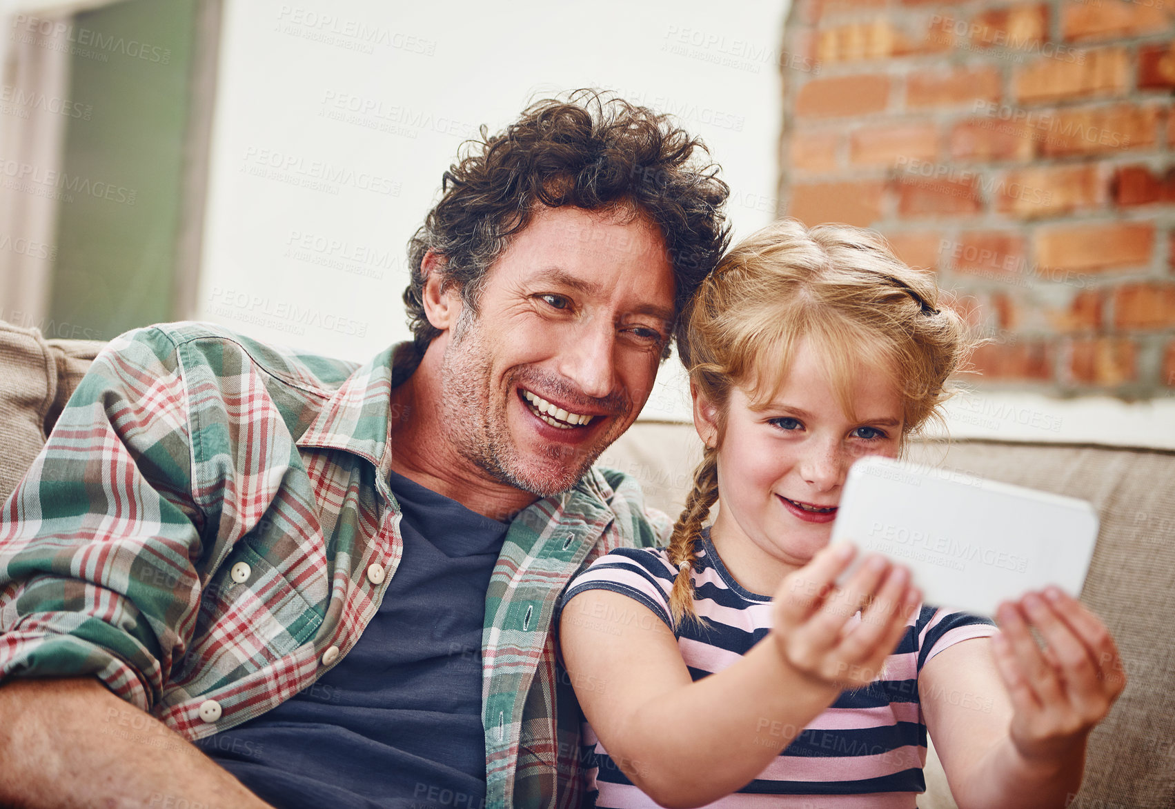 Buy stock photo Happy father, child and relax with selfie for picture, photography or memory together at home. Dad, daughter or little girl with smile for bonding, holiday or weekend moment on lounge couch at house