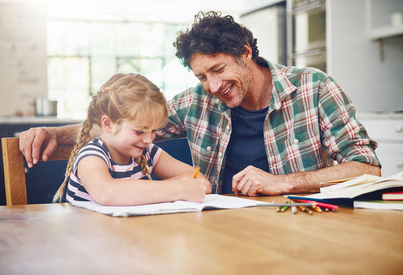 Buy stock photo Cropped shot of a father helping his daughter with her homework