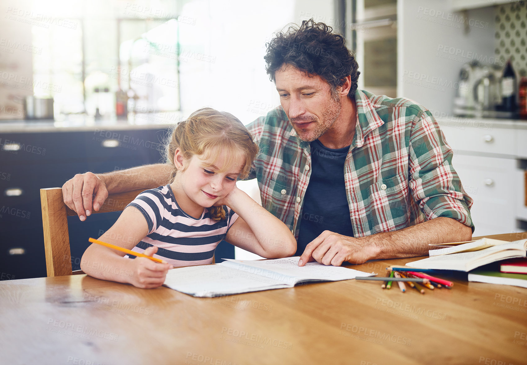 Buy stock photo Cropped shot of a father helping his daughter with her homework