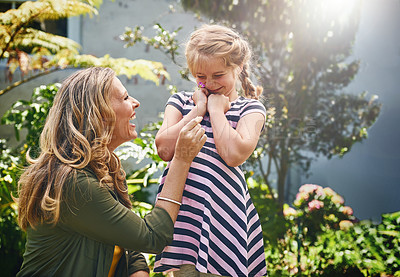 Buy stock photo Cropped shot of a mother and her little daughter bonding together outdoors