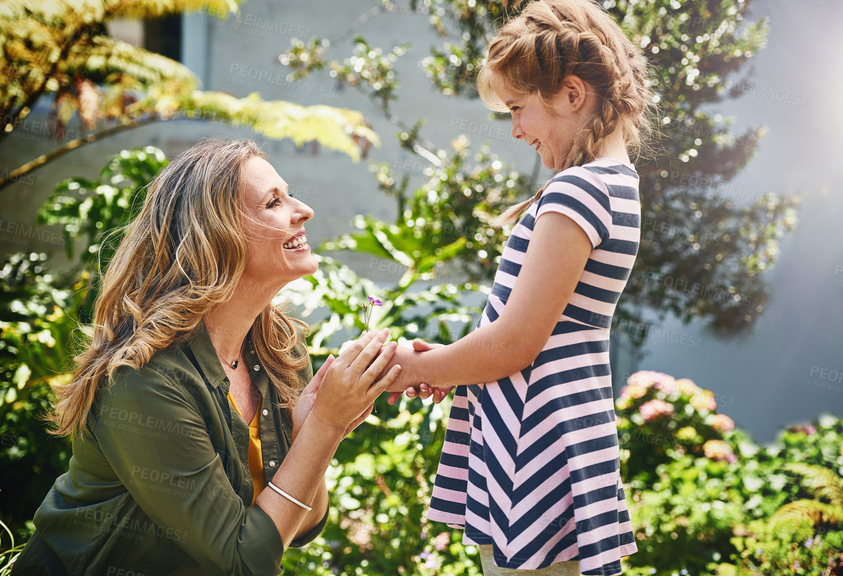 Buy stock photo Talking, love and mom and child in garden for conversation, laughing and having fun bonding together. Nature, smile and mature mother playing with girl in outdoor garden for family kid adventure